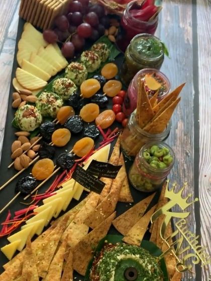 A classic charcuterie and cheese board, perfect for sophisticated gatherings. This platter features a curated selection of cheeses, dried fruits, nuts, and crackers, designed for pairing and sharing.