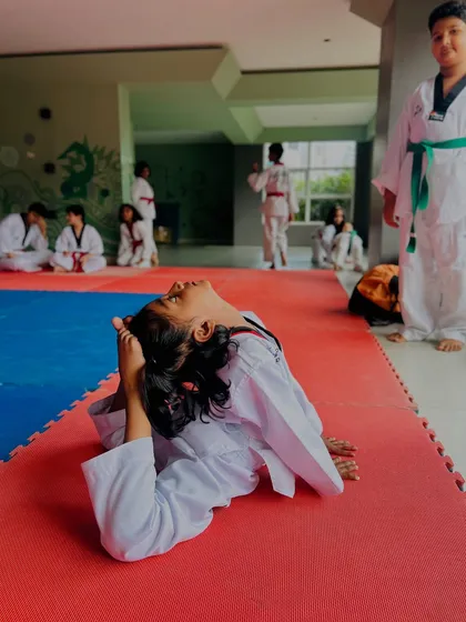Another young student mastering a difficult flexibility pose. This level of control is essential for advanced Taekwondo movements.