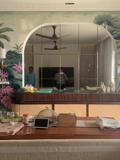 A wall mural can completely redefine a room. This wide view shows the scale of our nature mural, demonstrating how it integrates with the arched mirror and furniture to create a fully immersive, artistic atmosphere.