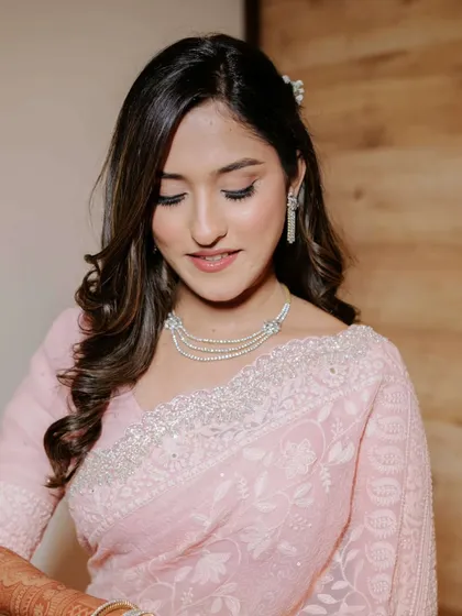 A close-up of this soft pink engagement makeup. The eyeshadow is blended for a subtle wash of color, paired with a matching lip and defined brows.