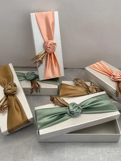 These elegant gift boxes with satin floral wraps are part of my custom curation service. I can create them in any color to perfectly match your wedding or event theme.