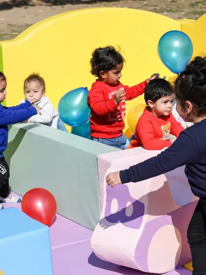 Little ones interacting and sharing toys in the soft play area, a great way to develop social skills.