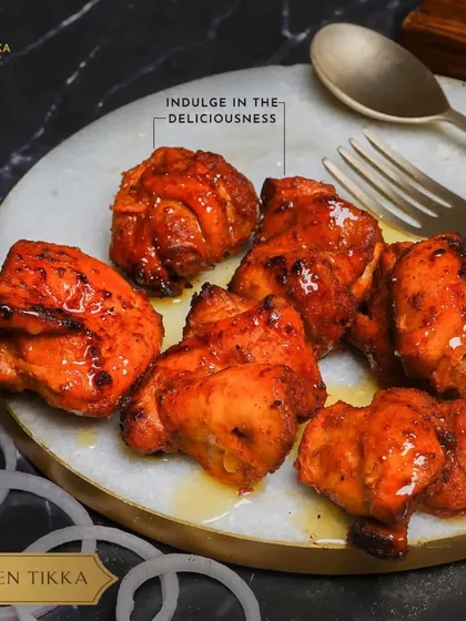 Another look at our delicious Chicken Tikka, with its vibrant red hue and juicy texture.