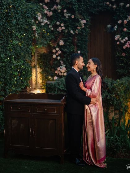 A classic, romantic portrait set against a beautiful wall of greenery and roses. This shot from a wedding reception at Gallops, Mumbai, is all about timeless elegance and romance.