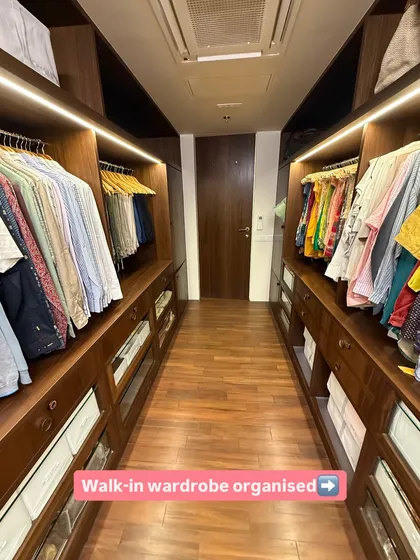 A long walk-in closet organized to create a gallery-like experience. By creating distinct zones on either side, we make the space feel both expansive and intuitive to navigate.