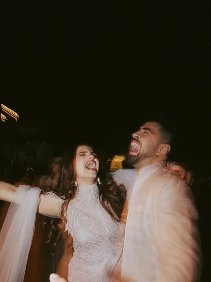 A moment of pure, uninhibited laughter between the couple during their Roka party. This candid, blurry shot perfectly captures the energy and joy of the moment.