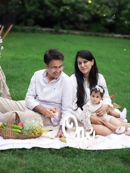A beautiful family portrait during their daughter's first birthday boho picnic. Capturing the parents' love and pride is just as important as the baby's milestone.