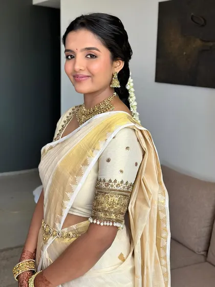 A portrait of my beautiful South Indian bride. Her makeup is fresh and radiant, with a soft rosy blush that complements the gold of her Kasavu saree.