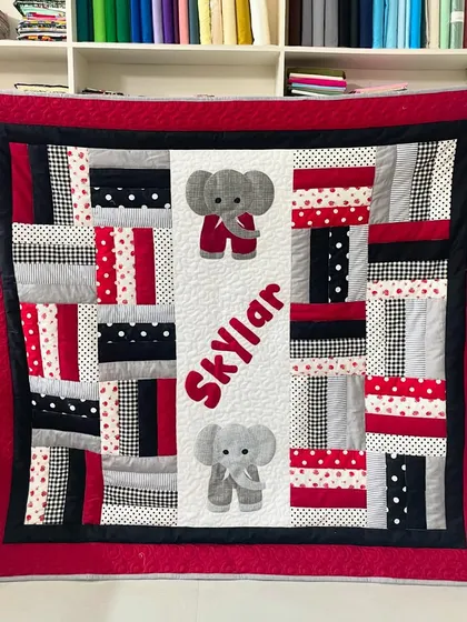 We create personalized quilts perfect for celebrating a new arrival. This adorable baby quilt for Skylar features custom name and elephant appliqués, all pieced and finished with durable longarm quilting to be loved for years.