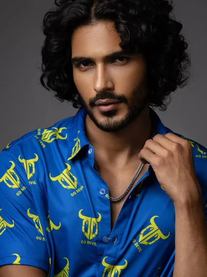 A close-up portrait for a men's casual wear brand. The focus is on the model's expression and the vibrant pattern of the shirt, creating a compelling image for a commercial campaign.