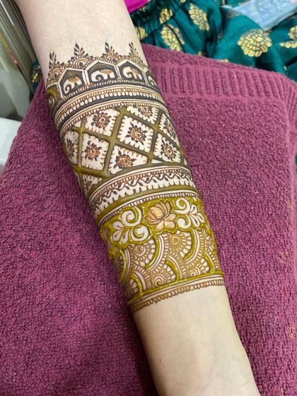 A closer look at the elephant cuff, a unique and personal element in this bride's full-arm mehendi design.
