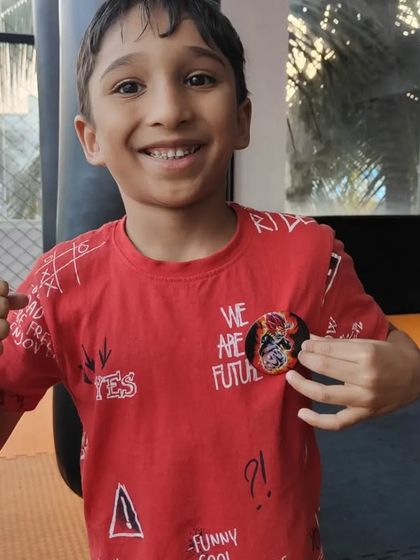 This young fighter proudly shows off his new badge after a great session. We use positive reinforcement to build confidence and motivate our students in every kids' jiu-jitsu class.