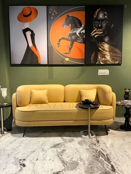 A full view of a living room featuring our vibrant yellow sofa. Paired with modern art and marble-topped side tables, it demonstrates how a single colorful piece can define and energize an entire space.