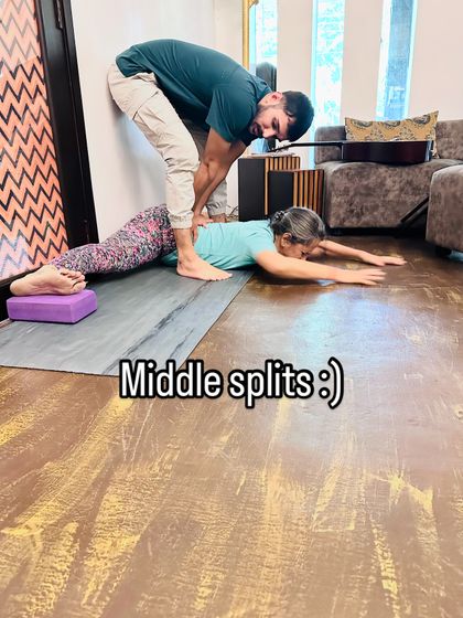 Working on middle splits with a student. I use gentle pressure and support to help her relax into the stretch and safely increase her hip flexibility over time.
