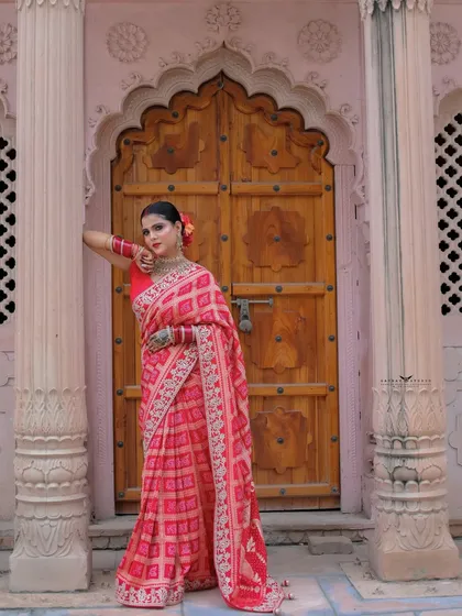 A full-length portrait with the model leaning against a pillar by the main door.
