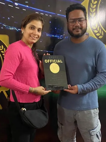 A member of our team receiving an official plaque, recognizing her contribution to the Sanshinkan Open.