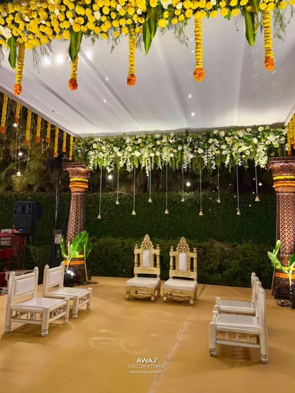 The mandap at night, with hanging bells and lights creating a warm and intimate glow for the evening ceremony.