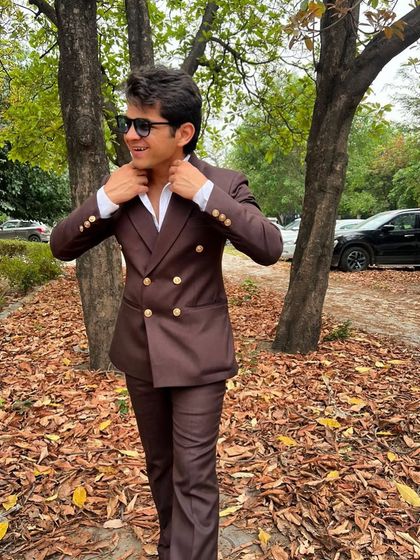 A young client looking sharp in a double-breasted brown suit with gold buttons. A classic, confident look for any formal occasion.