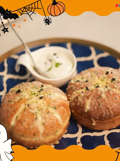 These cheesy garlic bread buns are a crowd favorite. They are soft, warm, and filled with melted cheese and garlic flavor, served with a creamy dip on the side. Perfect for a snack or appetizer.