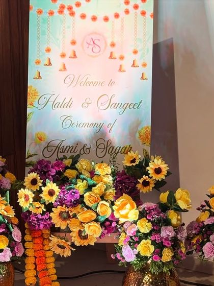 Another view of the beautiful welcome setup, showing how we combine personalized signage with fresh flowers to create a warm and inviting entrance.