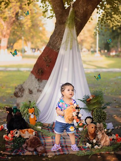 Exploring the great outdoors. This little girl is having so much fun during her park photoshoot, surrounded by nature and her furry friends.