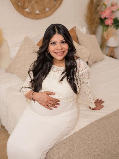 A radiant solo portrait of the mother-to-be, glowing with happiness.