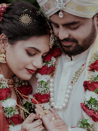 A tender moment where the couple is examining the bride's ring. This close up captures intimacy and the significance of the wedding jewelry.