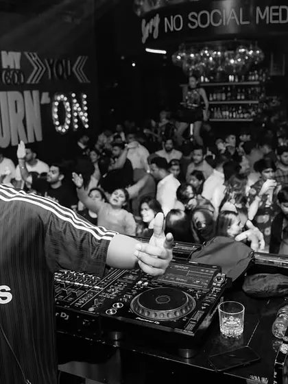 A moment of connection with the crowd. This black and white photo captures the feeling of being in complete control of the room's energy.