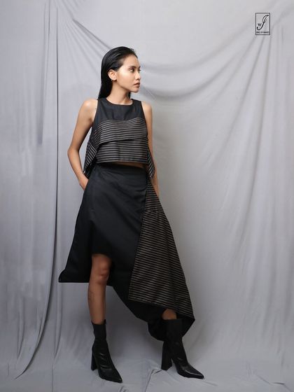 A thoughtful, off-camera glance adds a narrative quality to this high-fashion studio portrait.