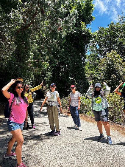 A group of women enjoying a walk through a forested path in Kodaikanal.