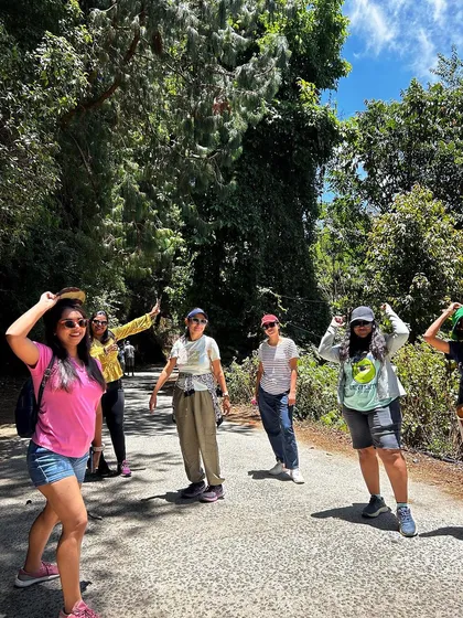 A group of women enjoying a walk through a forested path in Kodaikanal.