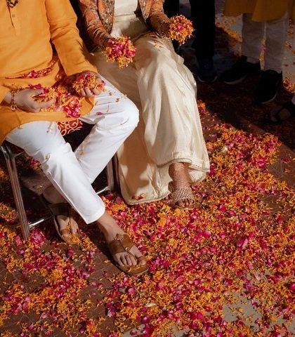 The aftermath of a joyous 'phoolon ki holi' at a Haldi ceremony. The ground covered in colorful petals tells the story of a fun-filled celebration.