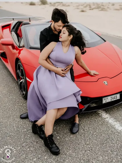 For the adventurous couple, a pre-wedding shoot in Dubai is an unforgettable experience. This shot with a vibrant red Lamborghini against the desert highway captures a story of modern luxury and romance.