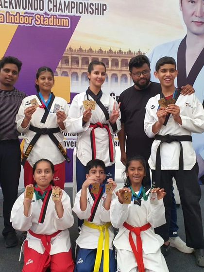 A mix of our junior and senior athletes showing off their medals. This picture captures the range of talent we nurture at KTA.