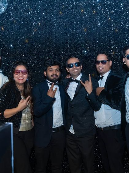 A group photo with the event host at the New Year's Eve party. We love connecting with our clients and their guests.