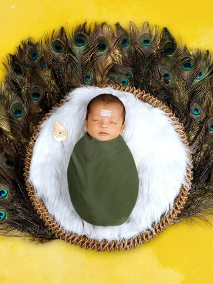Celebrating culture and tradition is a big part of what I do. This little one is styled as Lord Muruga, complete with peacock feathers and a sacred Vel, a creative concept that results in a unique and meaningful portrait.