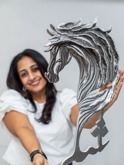 Holding the "Eternal Horse" sculpture. This piece combines untamed strength with refined luxury, a core theme in my work.