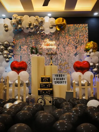 A brighter view of the black and silver anniversary decor. The "Happy Anniversary" neon sign and custom lightbox add a personal touch to your special day.