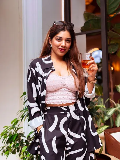 A stylish guest sips her wine, enjoying the sophisticated yet relaxed vibe of our brunch event.