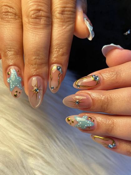 Starry vibes and a golden touch. This celestial-themed set features hand-painted stars, clouds, and gold chrome outlines, all accented with sparkling crystals.