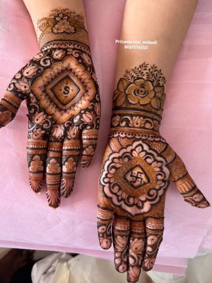 This design shows two ways to personalize your mehandi. One hand features the initial 'S' in a diamond frame, while the other incorporates a Swastika symbol for good fortune.