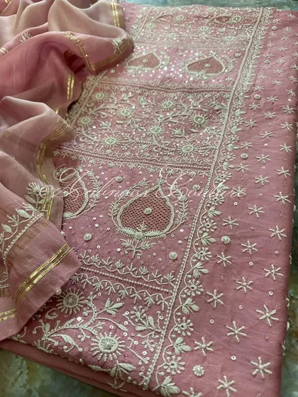 Another angle of the laid-out suit, focusing on the paisley motifs and the delicate seed pearl detailing.