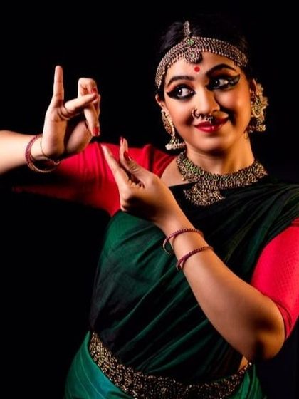 A striking portrait of Ms. Shweta Venkatesh, capturing the expressive eyes and hand mudras central to Indian classical dance.