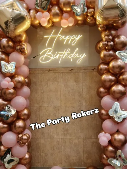Another view of the rose gold and pink balloon arch, a popular choice for creating a stylish and celebratory photo corner in any space.