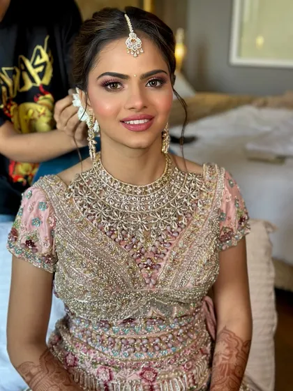 A direct and happy portrait. This image clearly shows the balanced soft glam makeup, from the defined brows to the subtle lip color, perfect for a modern bride.
