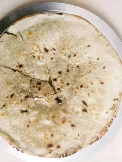 This is a traditional Kathiyawadi Kadak Bhakhri. It's a crispy, unleavened bread made from whole wheat flour that pairs wonderfully with sev tameta nu shaak or baingan bharta.
