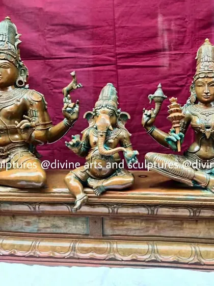 This is a complete Shiva Parivaram, or Shiva's family, featuring Lord Shiva, Goddess Parvati, and Lord Ganesha. The 24-inch Panchaloha sculpture is finished with an antique green oxide patina, giving it the timeless appearance of a treasured temple heirloom.