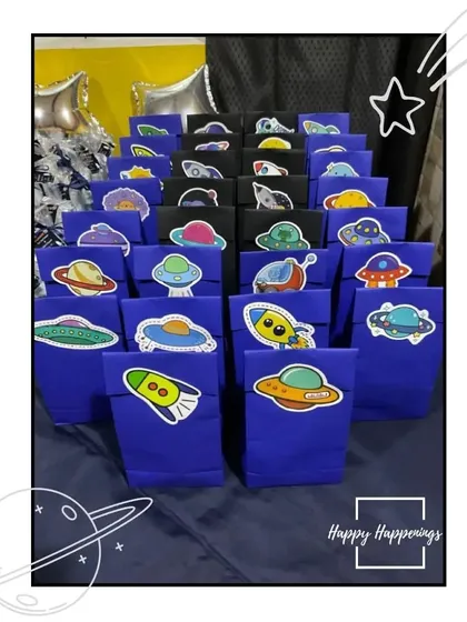 Party favors ready for the little astronauts to take home. These custom goody bags are decorated with fun space-themed stickers, ensuring the party fun continues even after it's over.