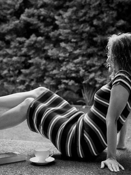 A playful, black and white shot in the striped dress, showing a moment of fun and spontaneity.