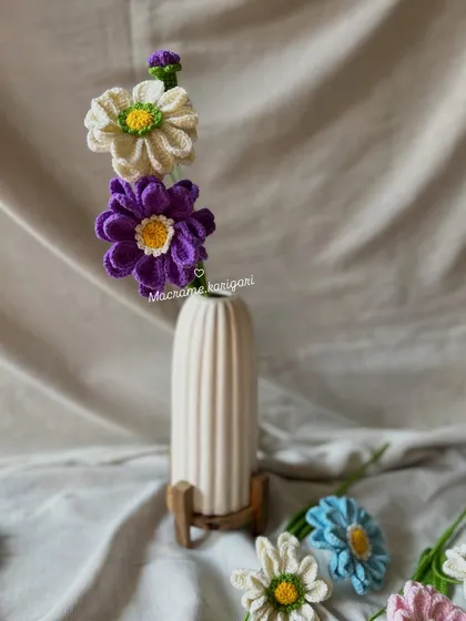 Our Zianna flowers, a mix of purple and white daisies, styled in a modern white vase. Each stem includes two flowers and a small bud for a realistic touch.